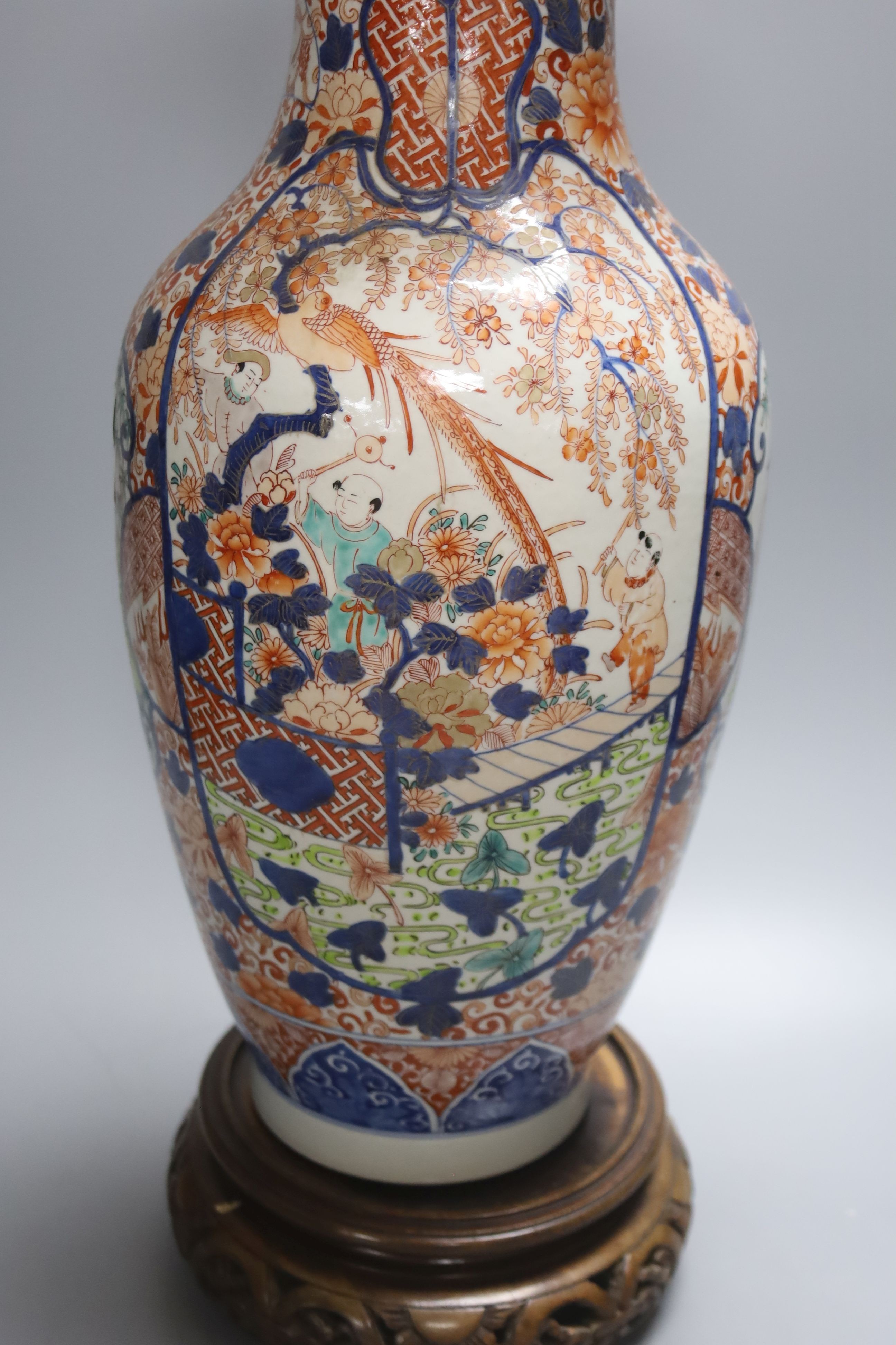 A large 20th century Japanese Arita porcelain vase, wood stand, restored 50cm